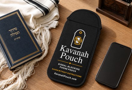 Kavanah Pouch signal-blocking phone pouch beside a siddur